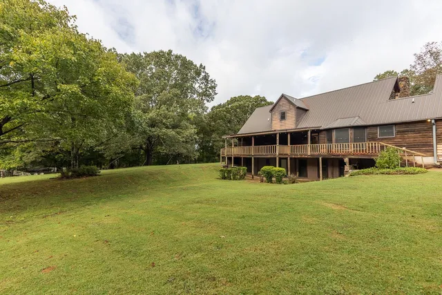 a front view of a house with a big yard