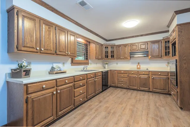 a kitchen with stainless steel appliances granite countertop a refrigerator and a sink