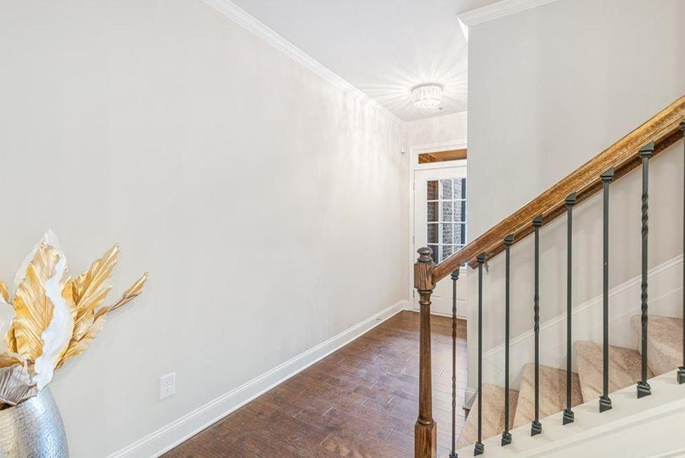 309 Braemore Mill Drive Lawrenceville, GA 30044 - Photo 5 of 9 a view of staircase with railing and white walls