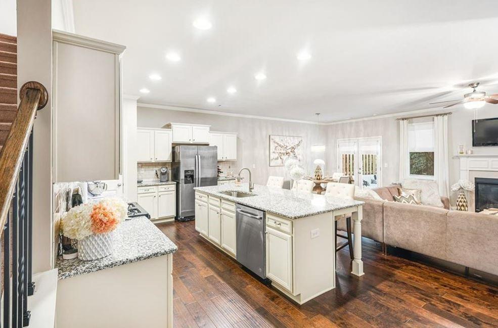 309 Braemore Mill Drive Lawrenceville, GA 30044 - Photo 6 of 9 a kitchen with counter top space sink stove and cabinets
