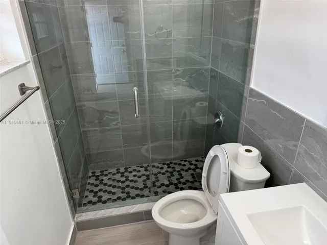 a bathroom with a toilet and a shower