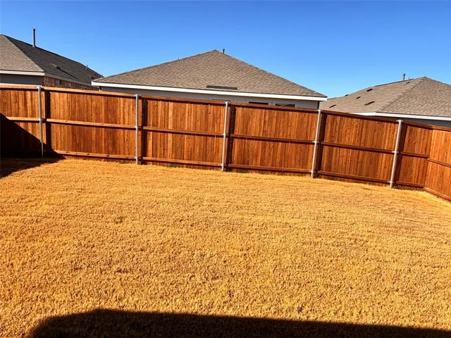 a view of an empty room with a small yard
