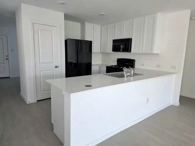 a room with refrigerator and cabinets