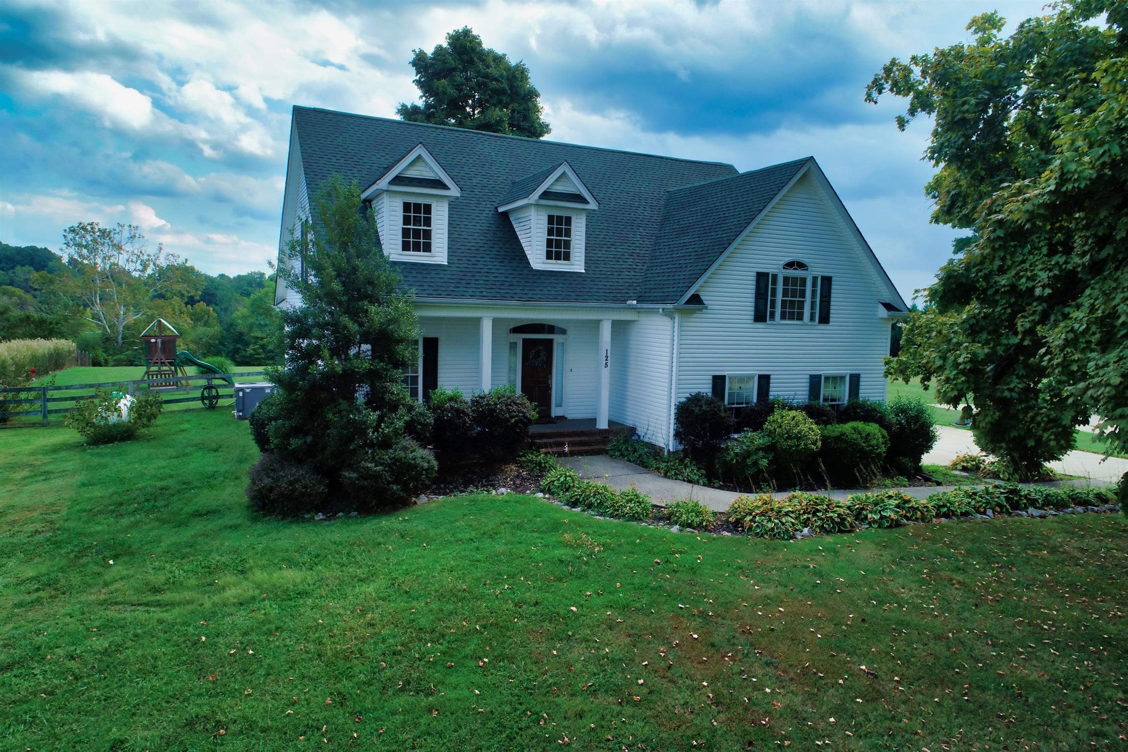 125 West Hester Road Cottontown, TN 37048 - Photo 1 of 28 a front view of a house with a yard