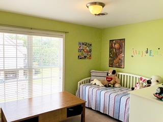 125 West Hester Road Cottontown, TN 37048 - Photo 13 of 28 a bedroom with a bed and wooden floor