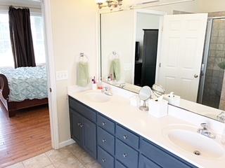 125 West Hester Road Cottontown, TN 37048 - Photo 18 of 28 a bathroom with a double vanity sink and mirror