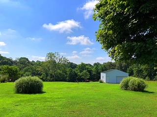 125 West Hester Road Cottontown, TN 37048 - Photo 22 of 28 a view of a garden with a building in the background