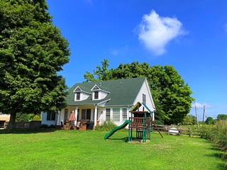 125 West Hester Road Cottontown, TN 37048 - Photo 23 of 28 a view of a house with a big yard and large trees