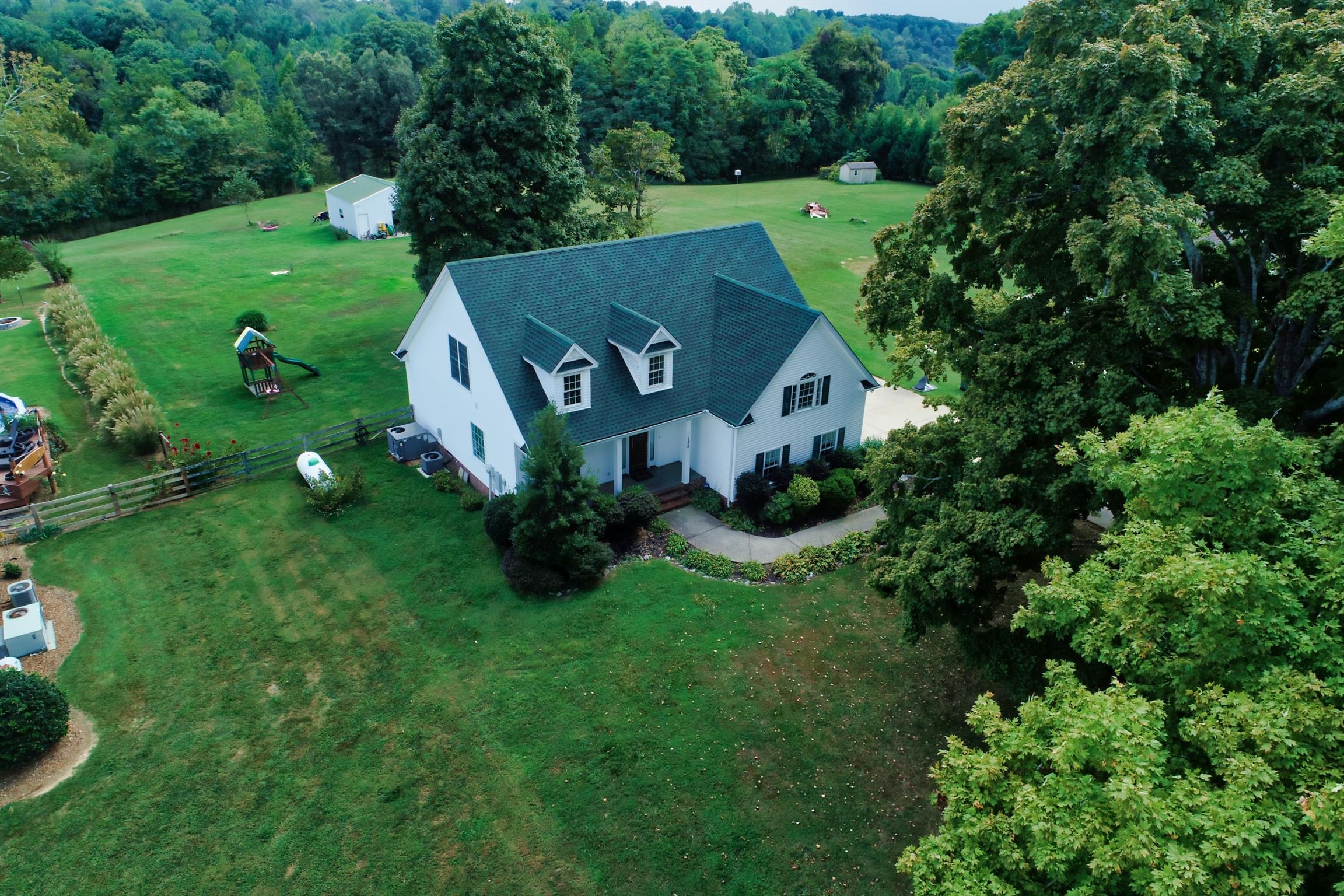 125 West Hester Road Cottontown, TN 37048 - Photo 25 of 28 a view of a house with a yard and potted plants