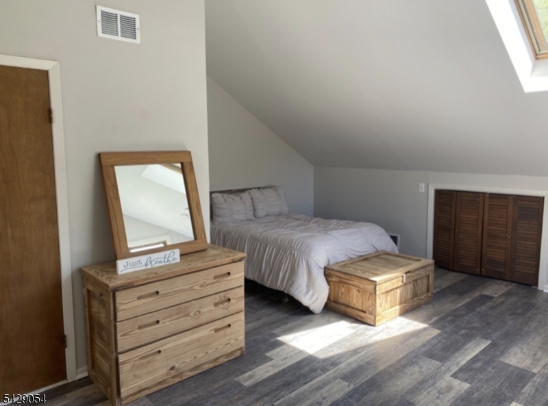 2 Acapulco Princess, Unit 4 Vernon, NJ 07462 - Photo 8 of 8 a bedroom with a bed and wooden floor