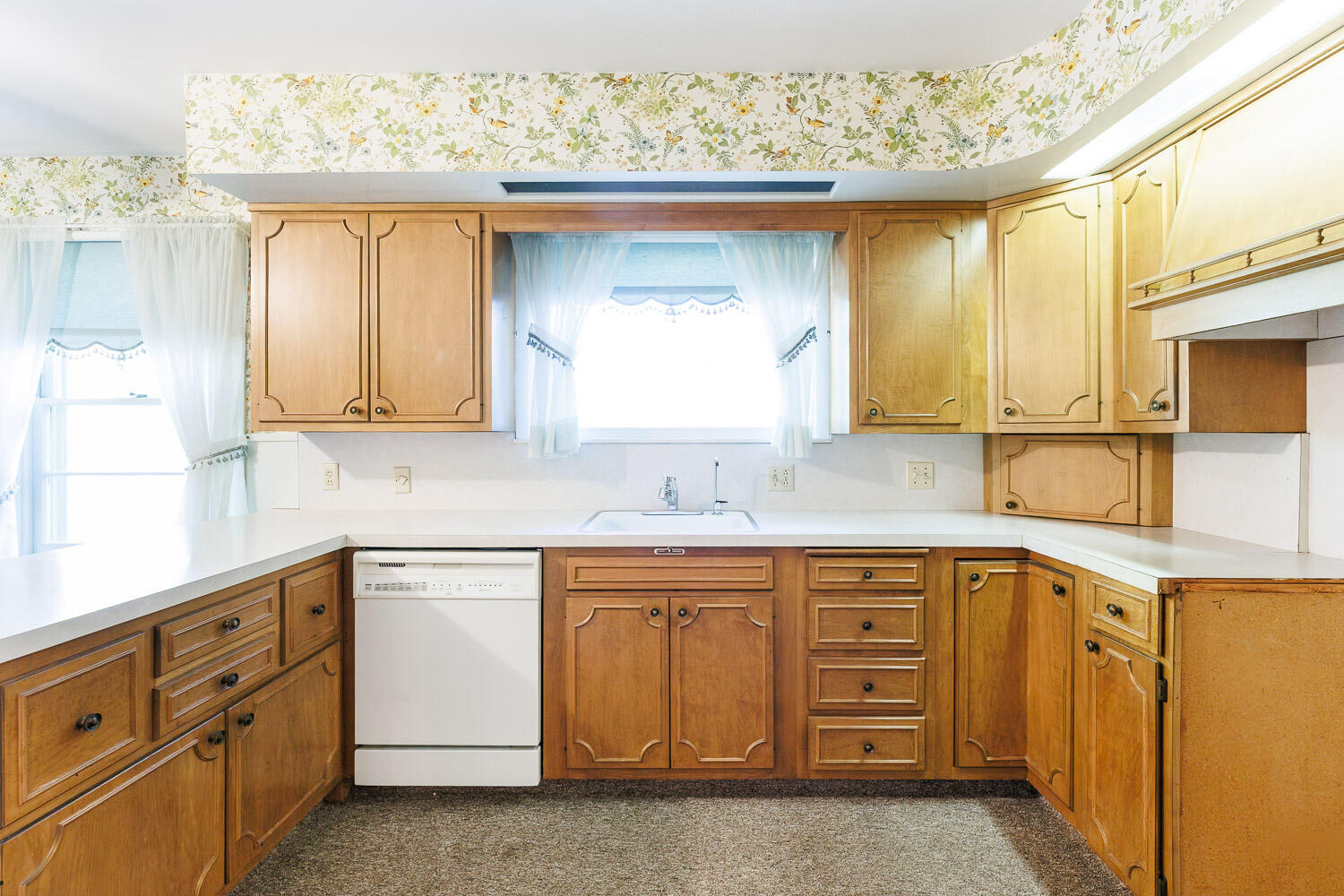 3308 37th Street Lubbock, TX 79413 - Photo 12 of 54 a kitchen with a sink dishwasher a stove and cabinets