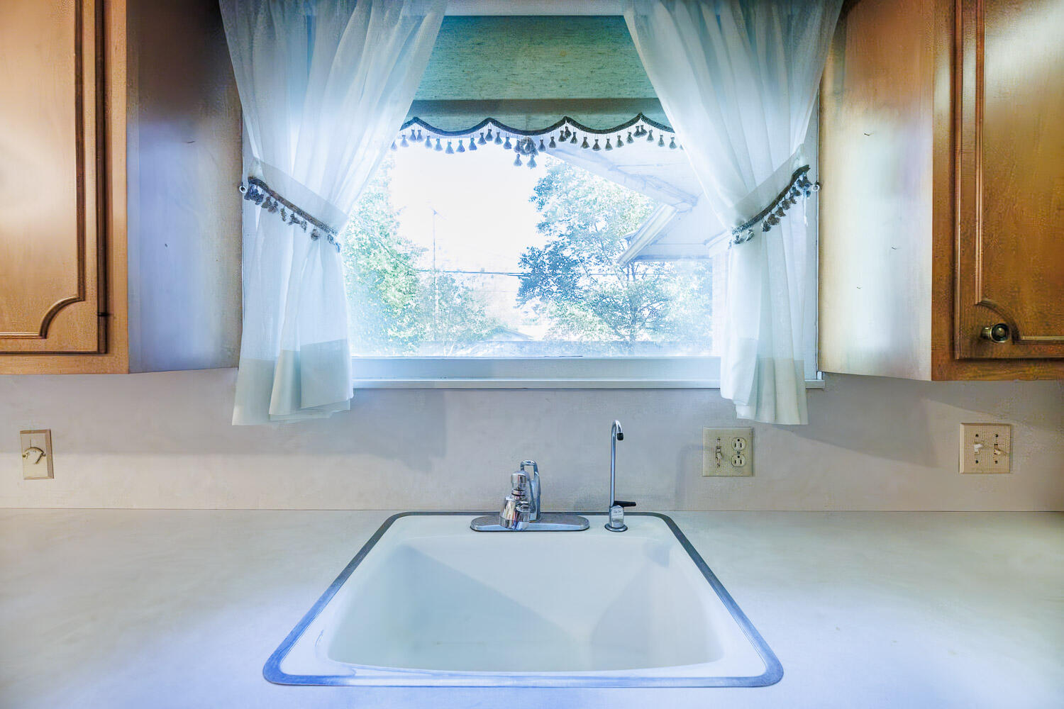 3308 37th Street Lubbock, TX 79413 - Photo 13 of 54 a bathroom with a sink and a large mirror