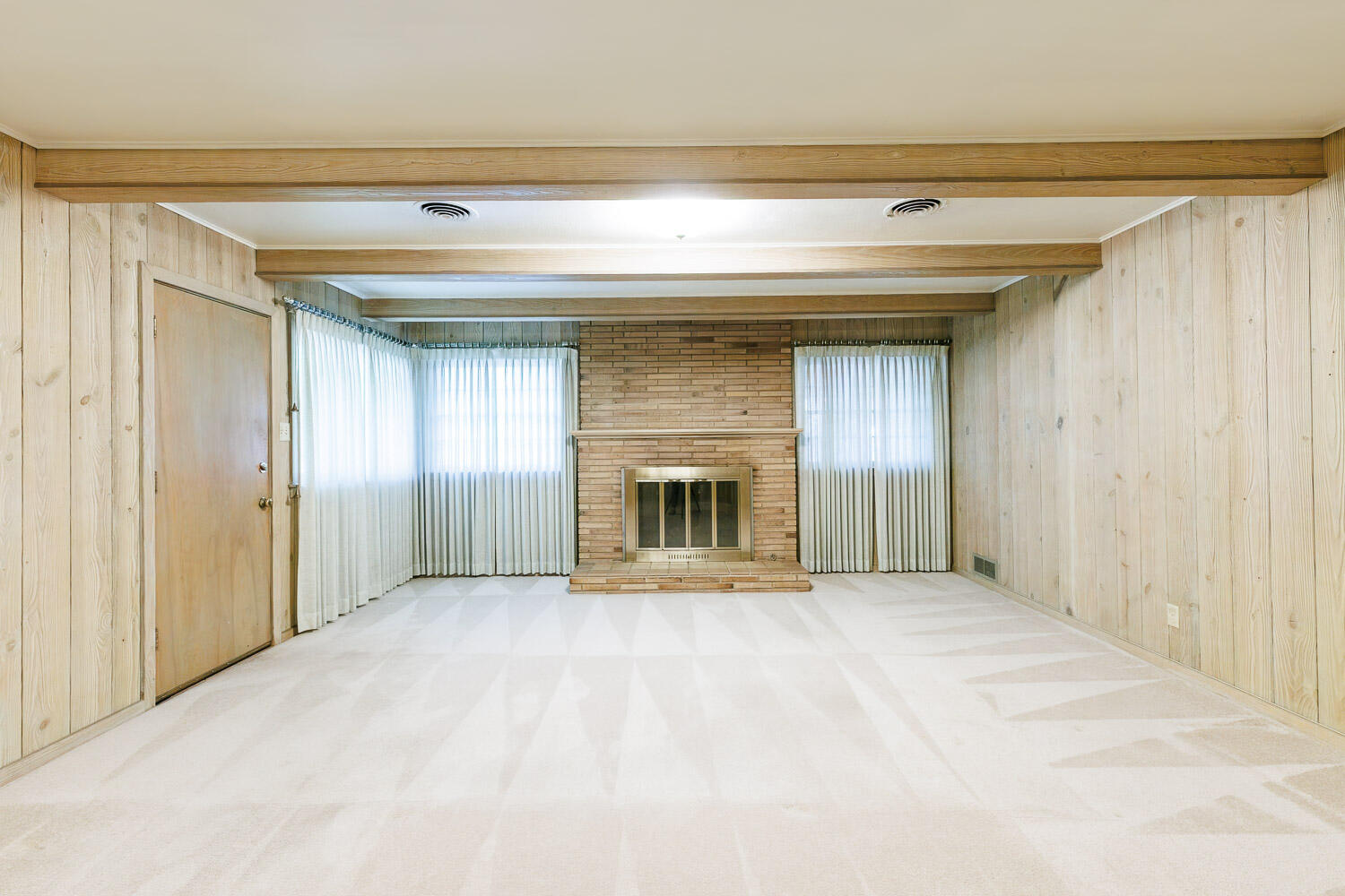 3308 37th Street Lubbock, TX 79413 - Photo 19 of 54 a view of an empty room with a fireplace and a window