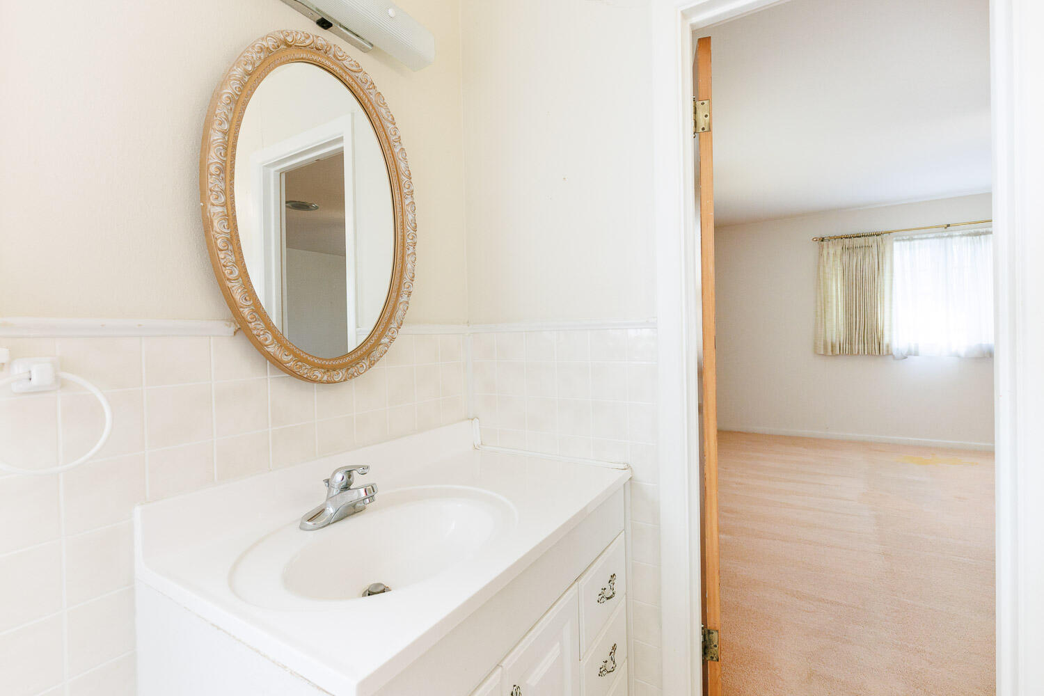 3308 37th Street Lubbock, TX 79413 - Photo 32 of 54 a bathroom with a sink and a mirror