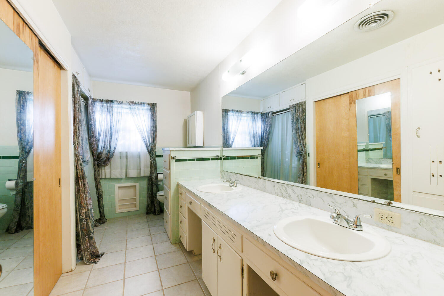 3308 37th Street Lubbock, TX 79413 - Photo 36 of 54 a bathroom with a granite countertop sink and a mirror