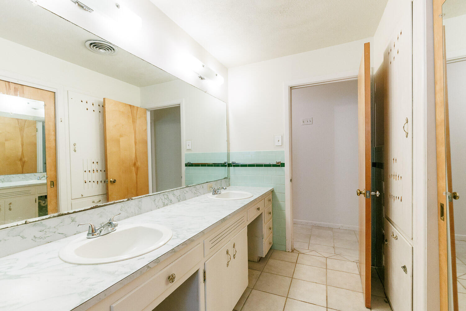 3308 37th Street Lubbock, TX 79413 - Photo 37 of 54 a bathroom with a granite countertop sink a mirror and a shower
