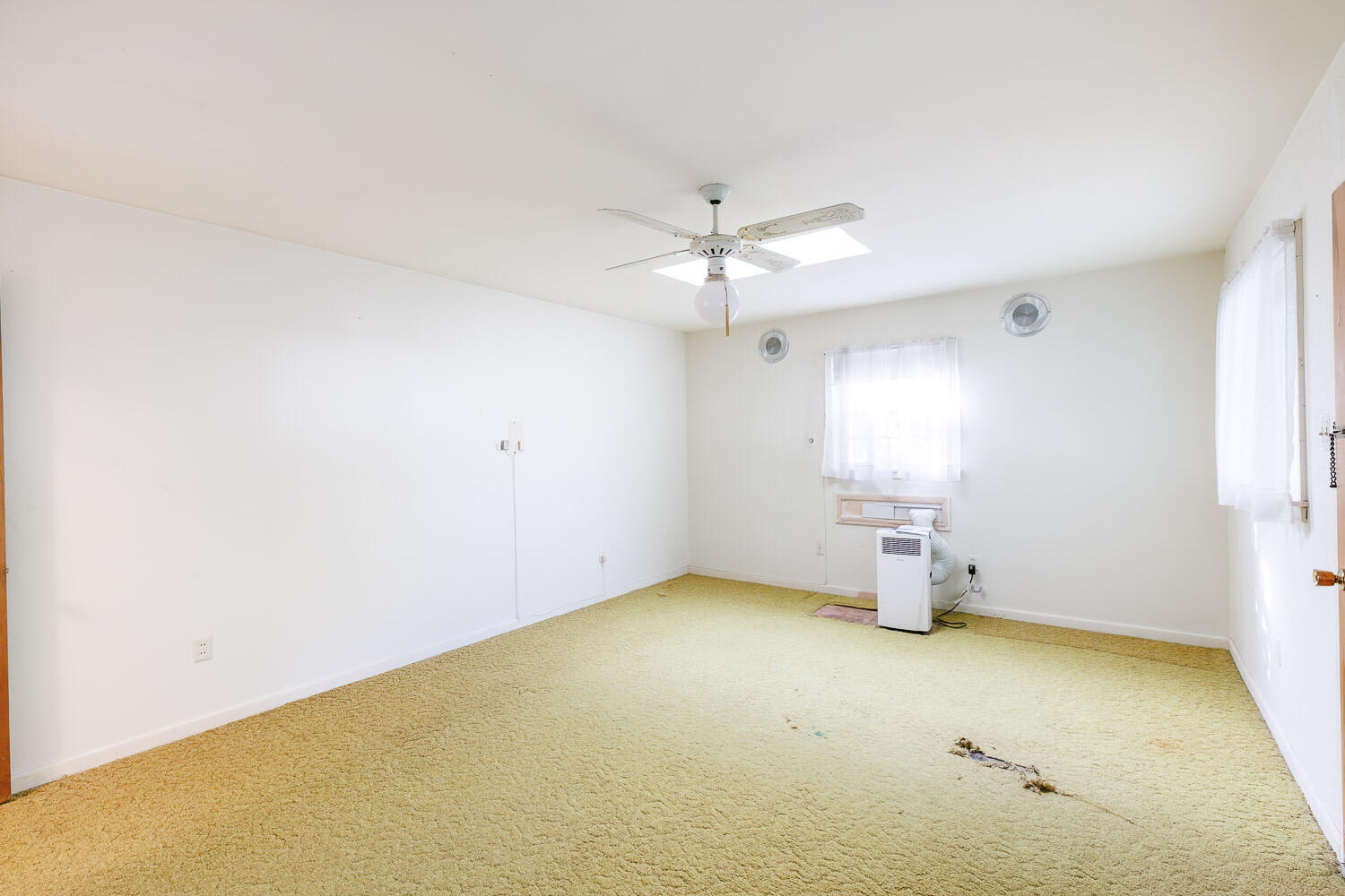 3308 37th Street Lubbock, TX 79413 - Photo 45 of 54 an empty room with a chandelier fan and windows