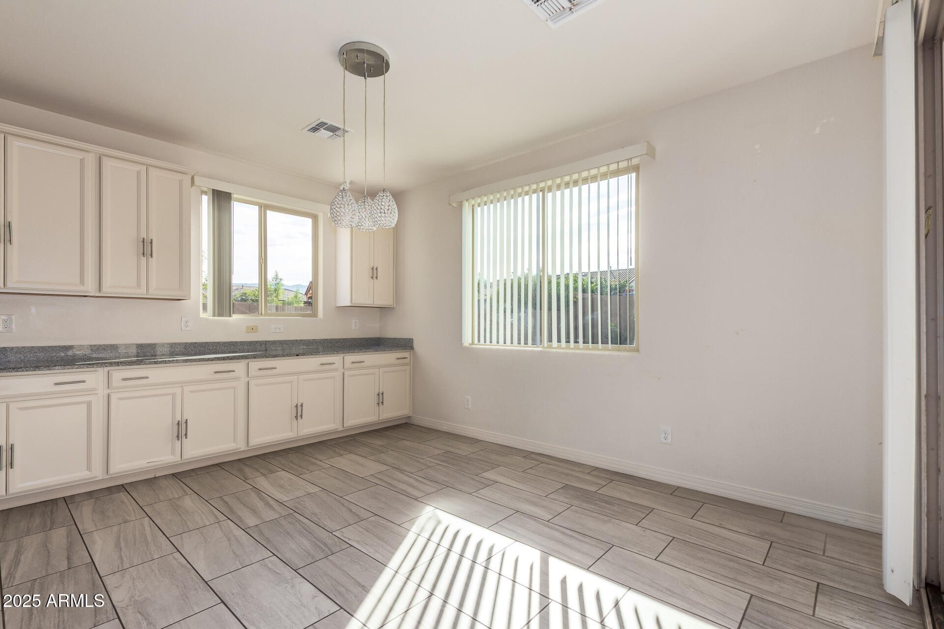 4515 West Pearce Road Laveen, AZ 85339 - Photo 10 of 35 a room with granite countertop white cabinets and window