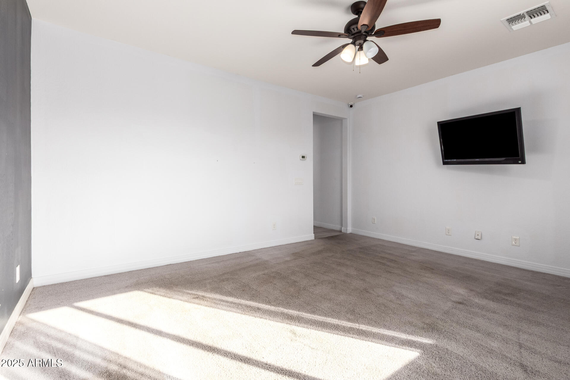 4515 West Pearce Road Laveen, AZ 85339 - Photo 16 of 35 a view of a livingroom with a flat screen tv