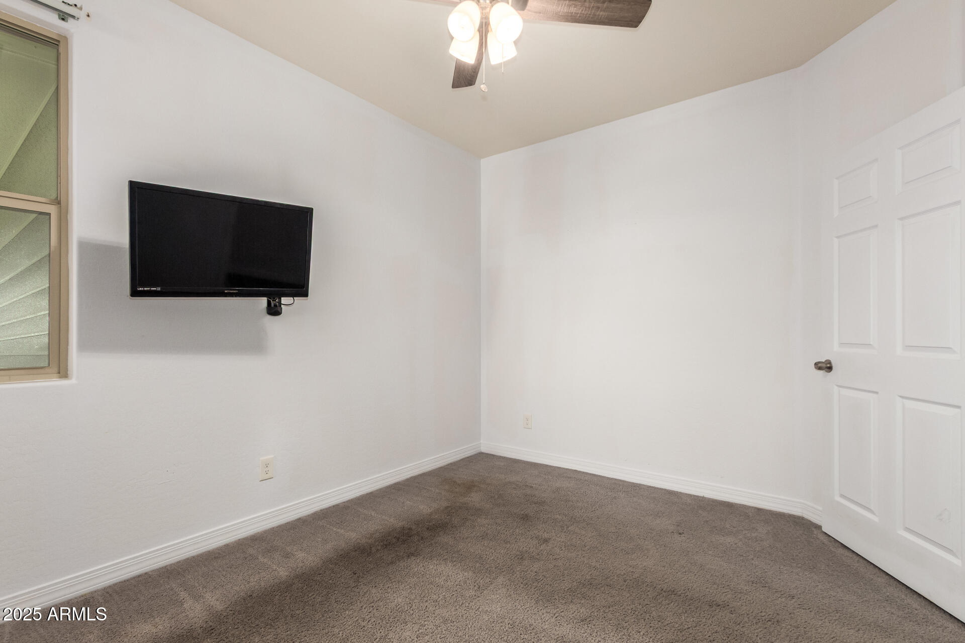 4515 West Pearce Road Laveen, AZ 85339 - Photo 19 of 35 a livingroom with a flat screen tv and a window