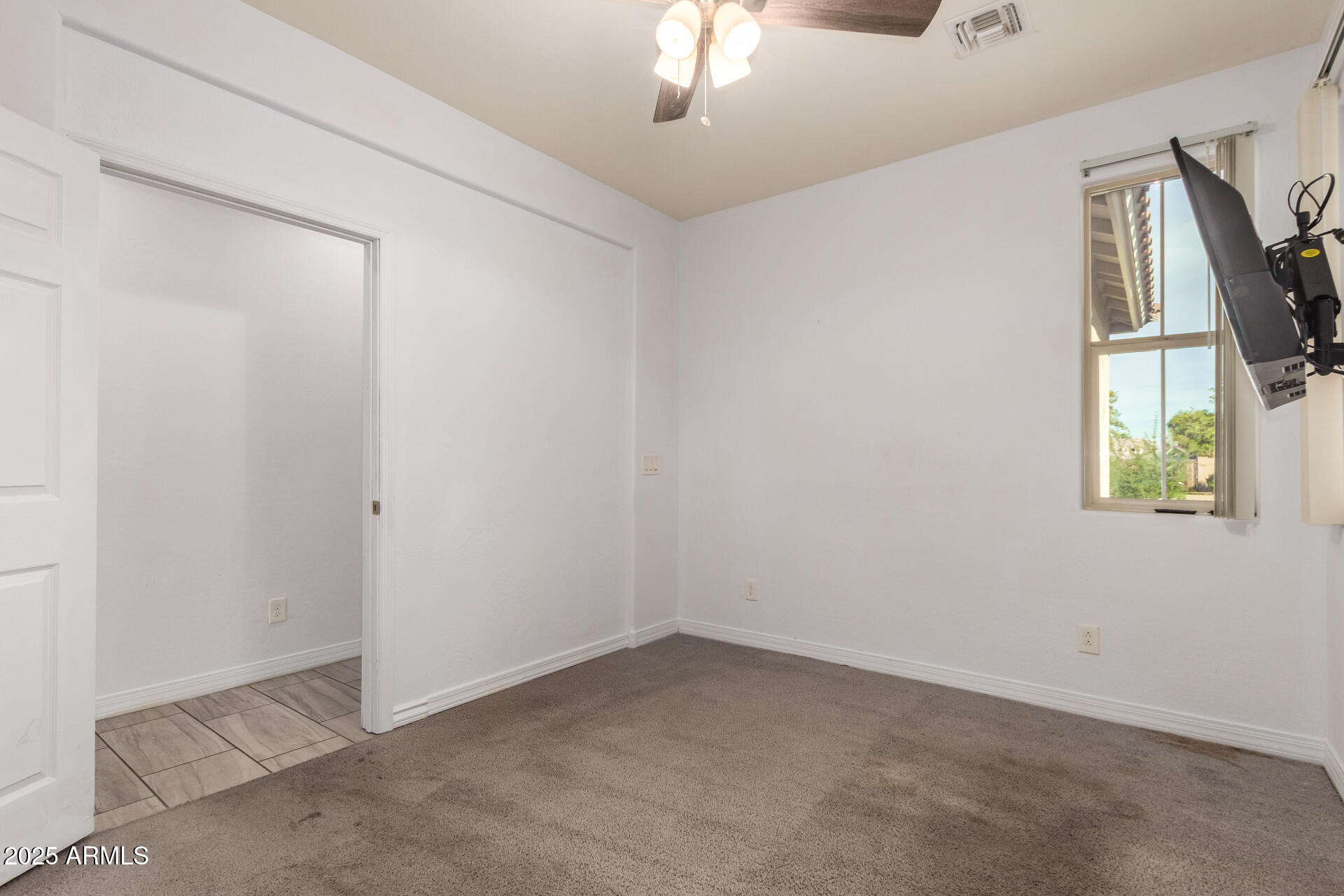 4515 West Pearce Road Laveen, AZ 85339 - Photo 20 of 35 an empty room with windows and entrance