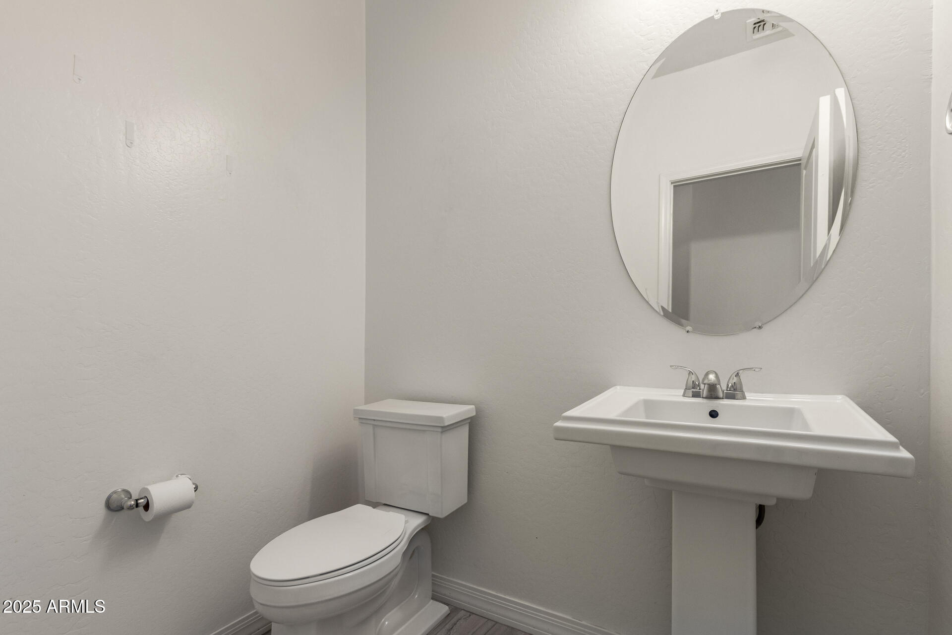4515 West Pearce Road Laveen, AZ 85339 - Photo 28 of 35 a bathroom with a toilet sink and mirror