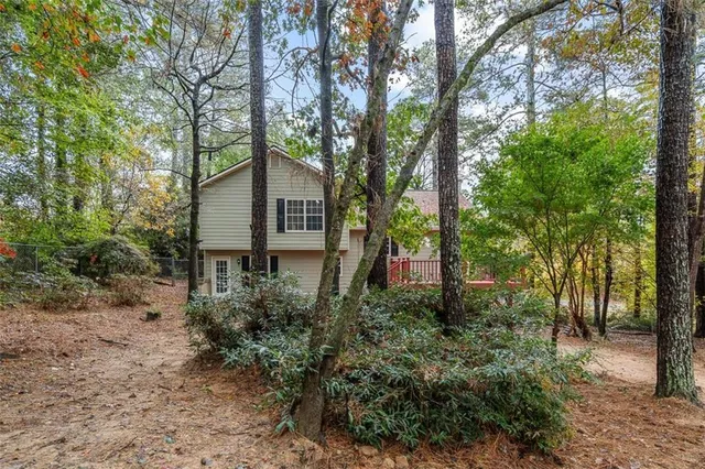 a view of a house with large trees