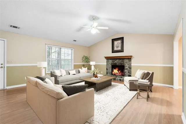 a living room with furniture and a fireplace