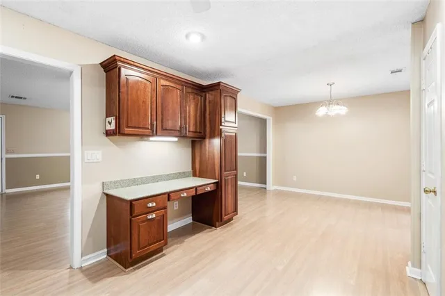 a kitchen with stainless steel appliances granite countertop a refrigerator a sink and a stove