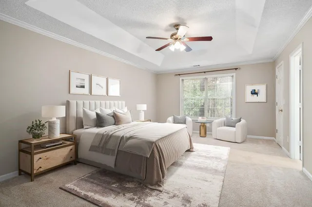 a bedroom with a large bed and a chandelier
