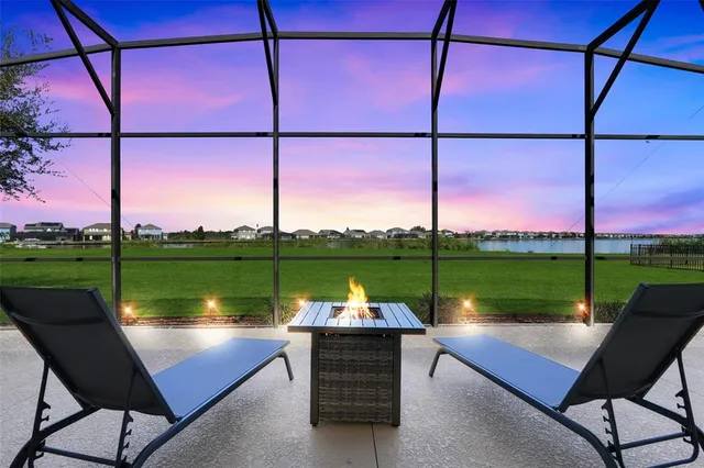 a view of a lake with couches of wooden floor and lake view