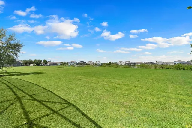 an aerial view of residential houses with outdoor space and ocean