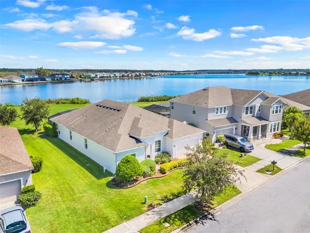 an aerial view of a house with a swimming pool outdoor seating and yard