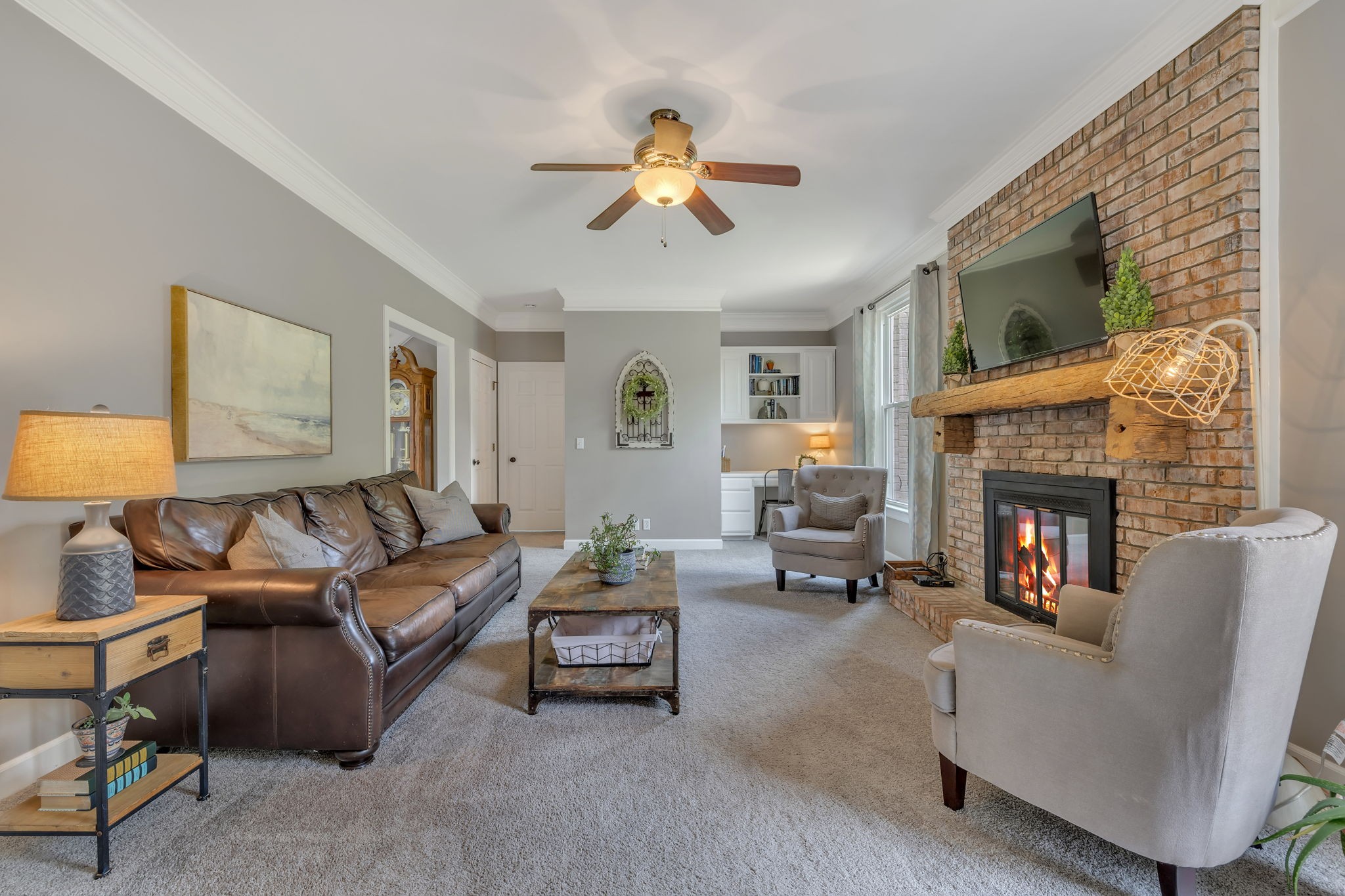 2226 Oakleaf Drive Franklin, TN 37064 - Photo 12 of 70 a living room with furniture a fireplace and a flat screen tv