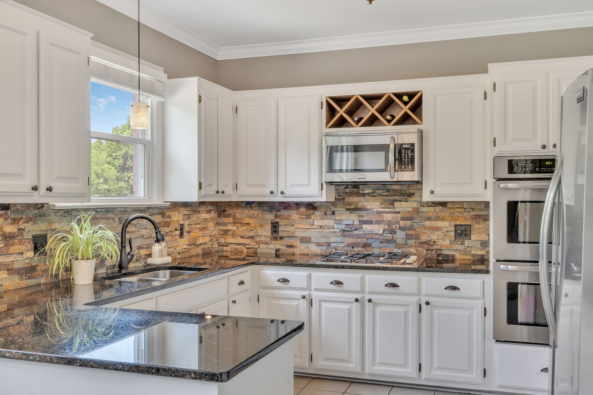 2226 Oakleaf Drive Franklin, TN 37064 - Photo 19 of 70 a kitchen with granite countertop a sink stainless steel appliances and cabinets
