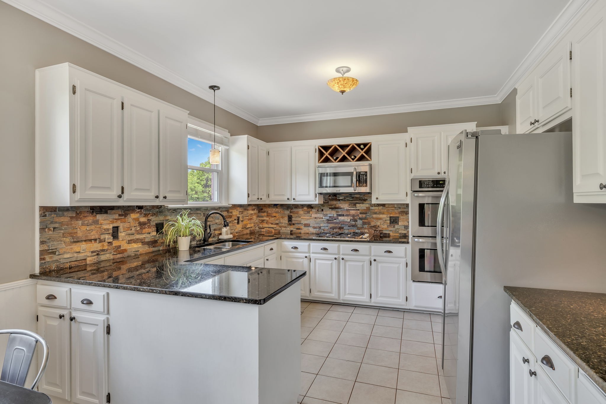 2226 Oakleaf Drive Franklin, TN 37064 - Photo 20 of 70 a kitchen with stainless steel appliances granite countertop a sink stove and refrigerator