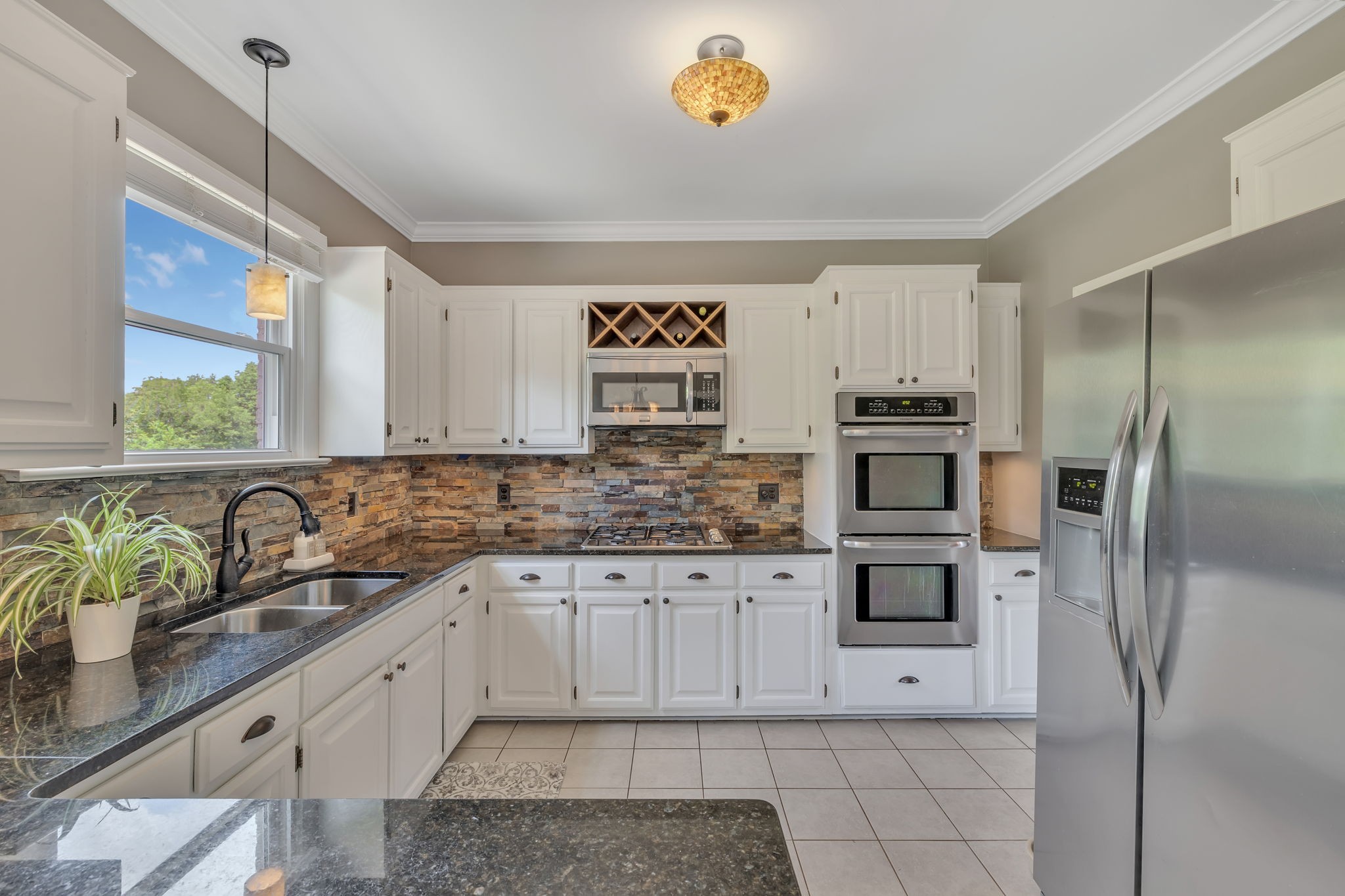 2226 Oakleaf Drive Franklin, TN 37064 - Photo 21 of 70 a kitchen with stainless steel appliances a sink a stove a refrigerator and a window