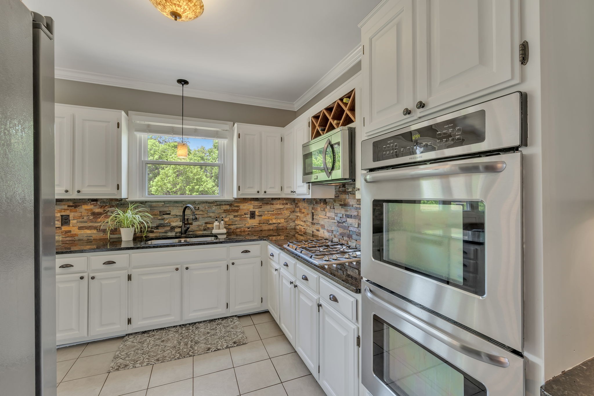 2226 Oakleaf Drive Franklin, TN 37064 - Photo 24 of 70 a kitchen with granite countertop white cabinets and white appliances
