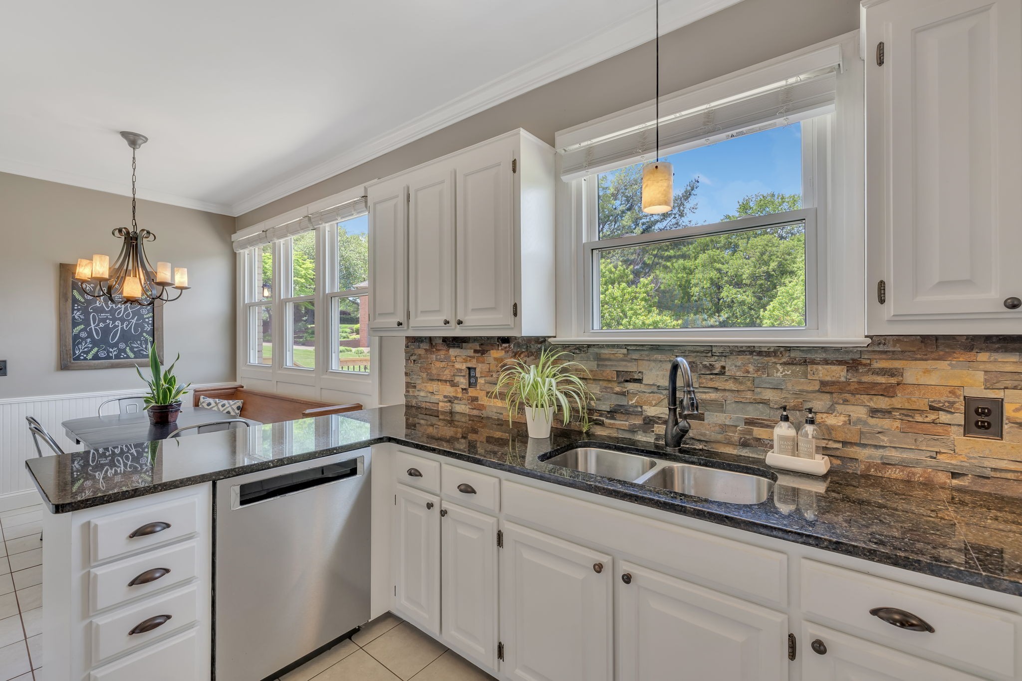 2226 Oakleaf Drive Franklin, TN 37064 - Photo 26 of 70 a kitchen with stainless steel appliances granite countertop white cabinets a potted plant and a window