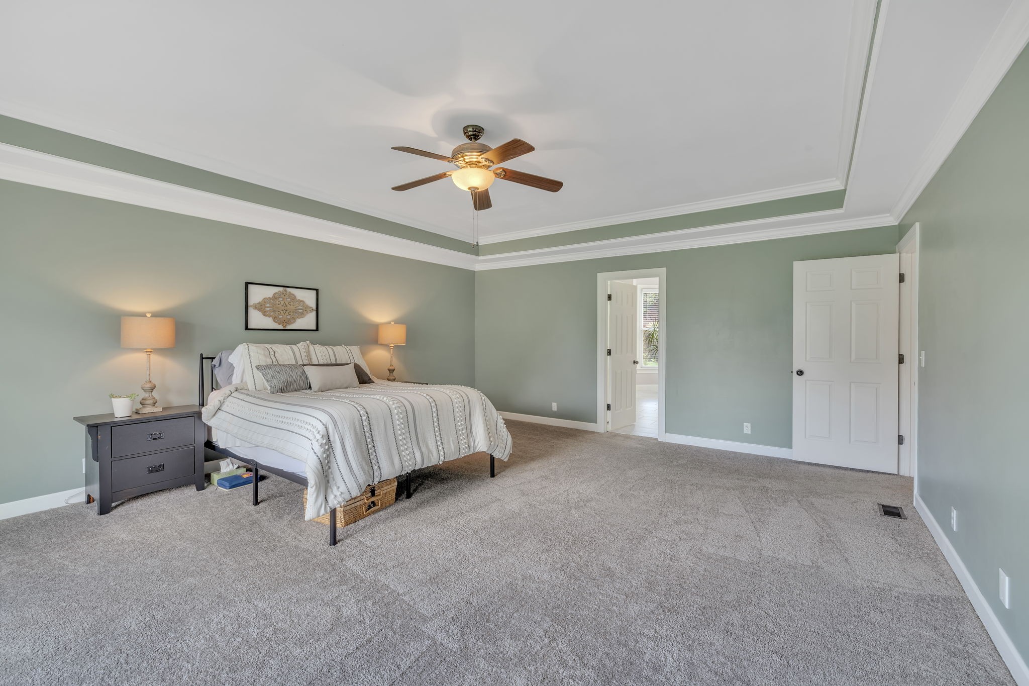 2226 Oakleaf Drive Franklin, TN 37064 - Photo 30 of 70 a spacious bedroom with a bed and a chandelier