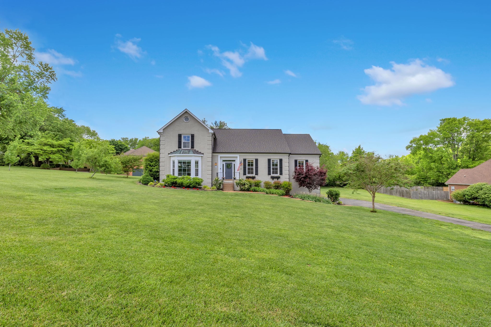 2226 Oakleaf Drive Franklin, TN 37064 - Photo 3 of 70 a front view of a house with a big yard and potted plants