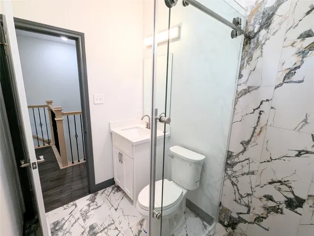 a bathroom with a toilet a sink and a shower