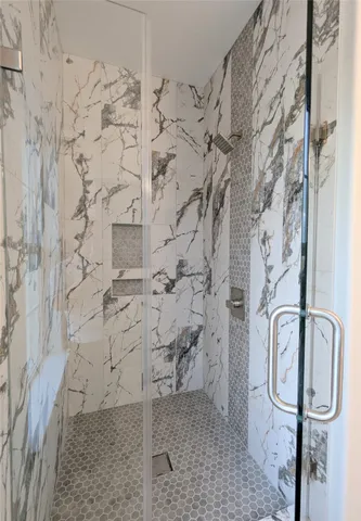 a view of a hallway with wooden floor and a fireplace