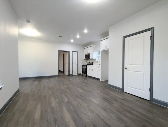 a view of a kitchen with a sink and a refrigerator