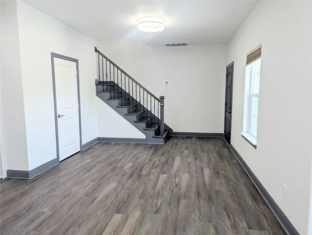 a view of entryway and hall with wooden floor