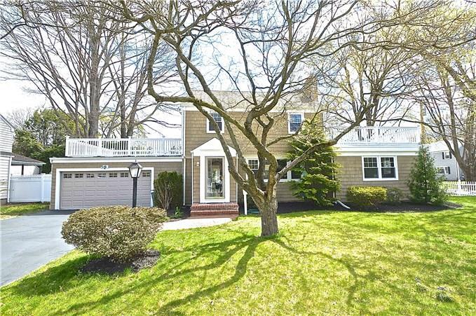 a view of a house with a large tree in front of a house