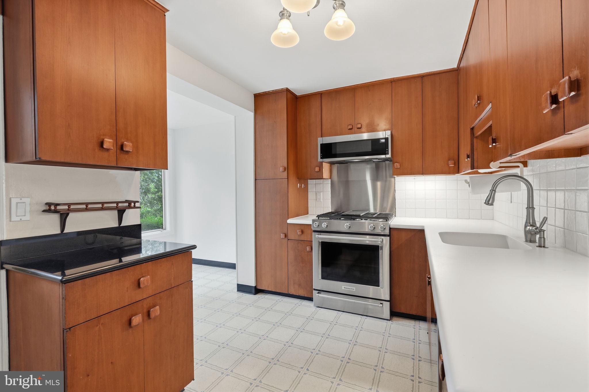 404 Old Farm Road Wyncote, PA 19095 - Photo 13 of 41 Modern kitchen with warm wood tones.