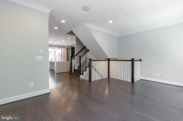 a large white kitchen with a large window and stainless steel appliances