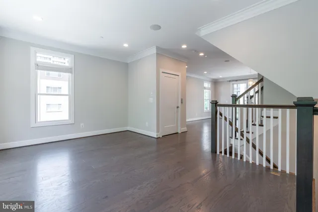 a view of kitchen with kitchen island wooden floor and living room
