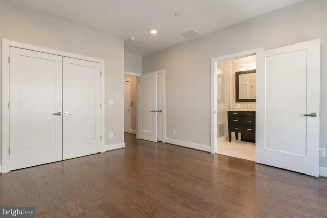 a bathroom with a granite countertop sink a mirror and a shower